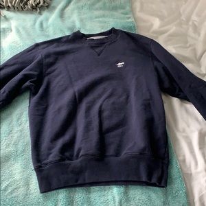 navy blue champion sweatshirt with white symbol